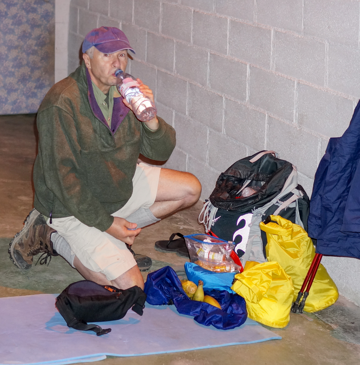 A Camino pilgrim prepares for morning departure from Albergue Escula, Zubiri, Spain | Photo by Mike Hudak