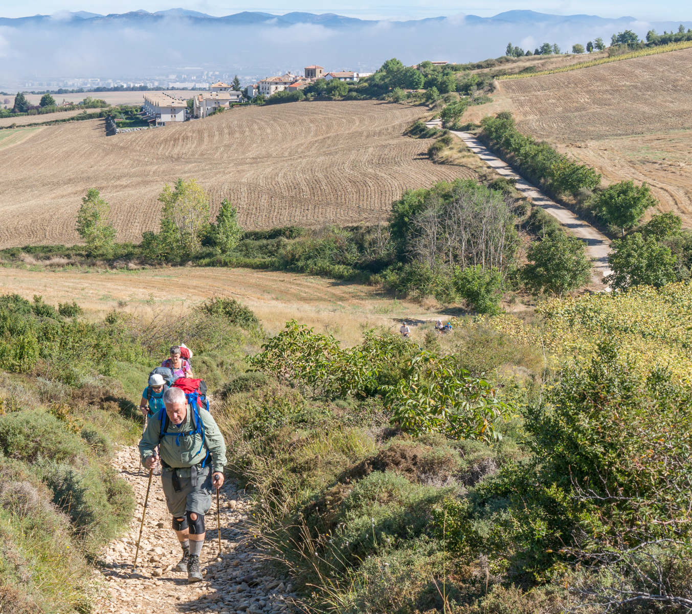 Camino pilgrims ascend Alto del Perdón mountain range (Mountains of Forgiveness) west of Pamplona, Spain | Photo by Mike Hudak