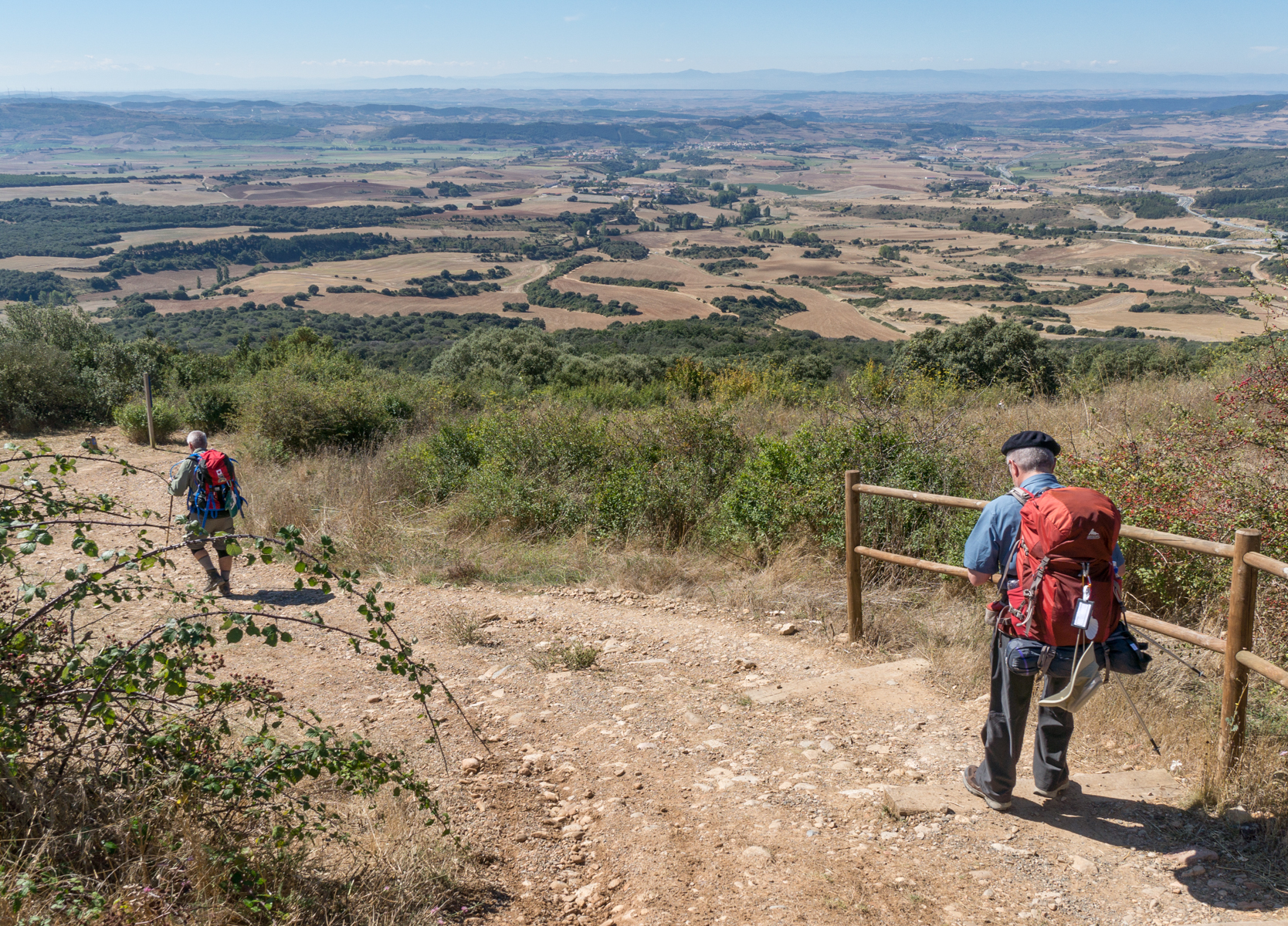 Camino Francés pilgrims descend the western slope of Alto del Perdón, Spain | Photo by Mike Hudak