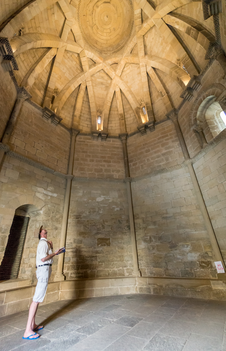 A Camino pilgrim contemplates the ceiling of the 12th century Iglesia de Santo Sepulcro, Torres del Rio, Spain | Photo by Mike Hudak