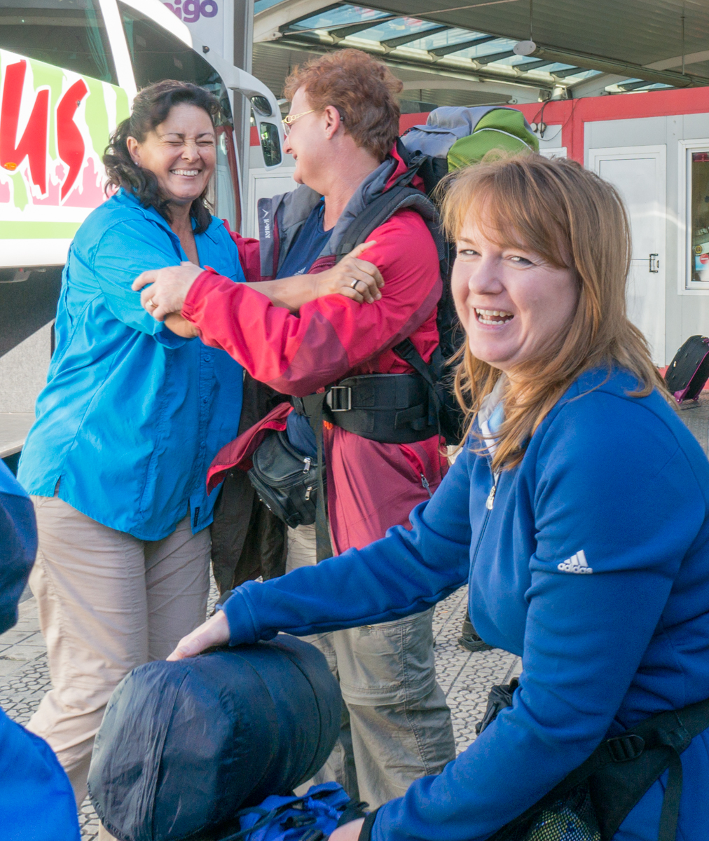 Camino pilgrims say goodbyes to one another at bus station in Bilbao, Spain | Photo by Mike Hudak