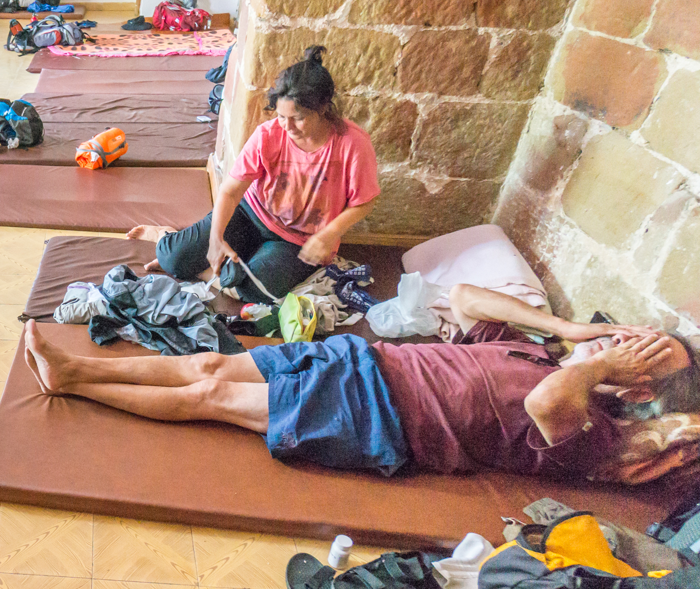 Camino pilgrims on floor of the Albergue San Juan Bautista in Granon | Photo by Mike Hudak