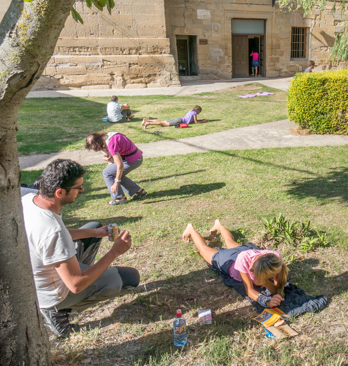 Camino pilgrims relax on lawn behind  Albergue San Juan Bautista | Photo by Mike Hudak