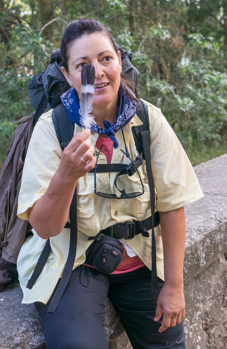 A Camino pilgrim holds up a feather in Burgos, Spain | Photo by Mike Hudak