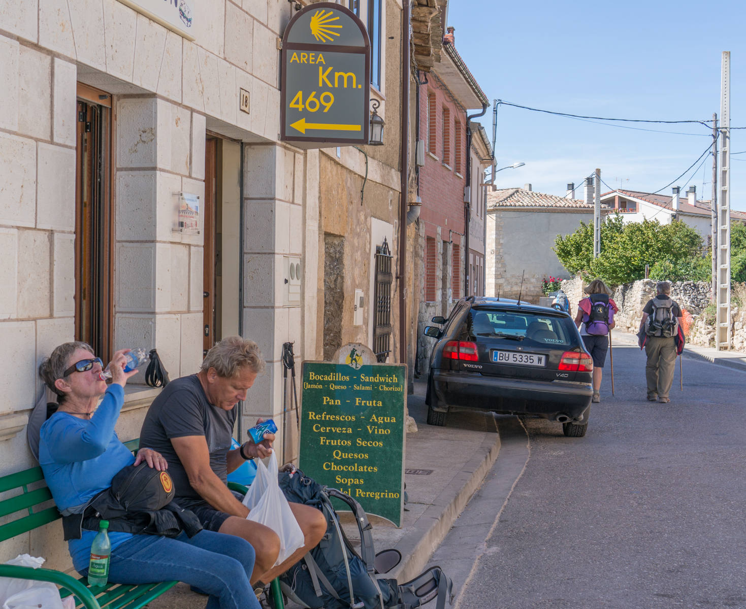 Camino pilgrims enjoy snacks outside a small grocery store in Hornillos del Camino, Spain | Photo by Mike Hudak