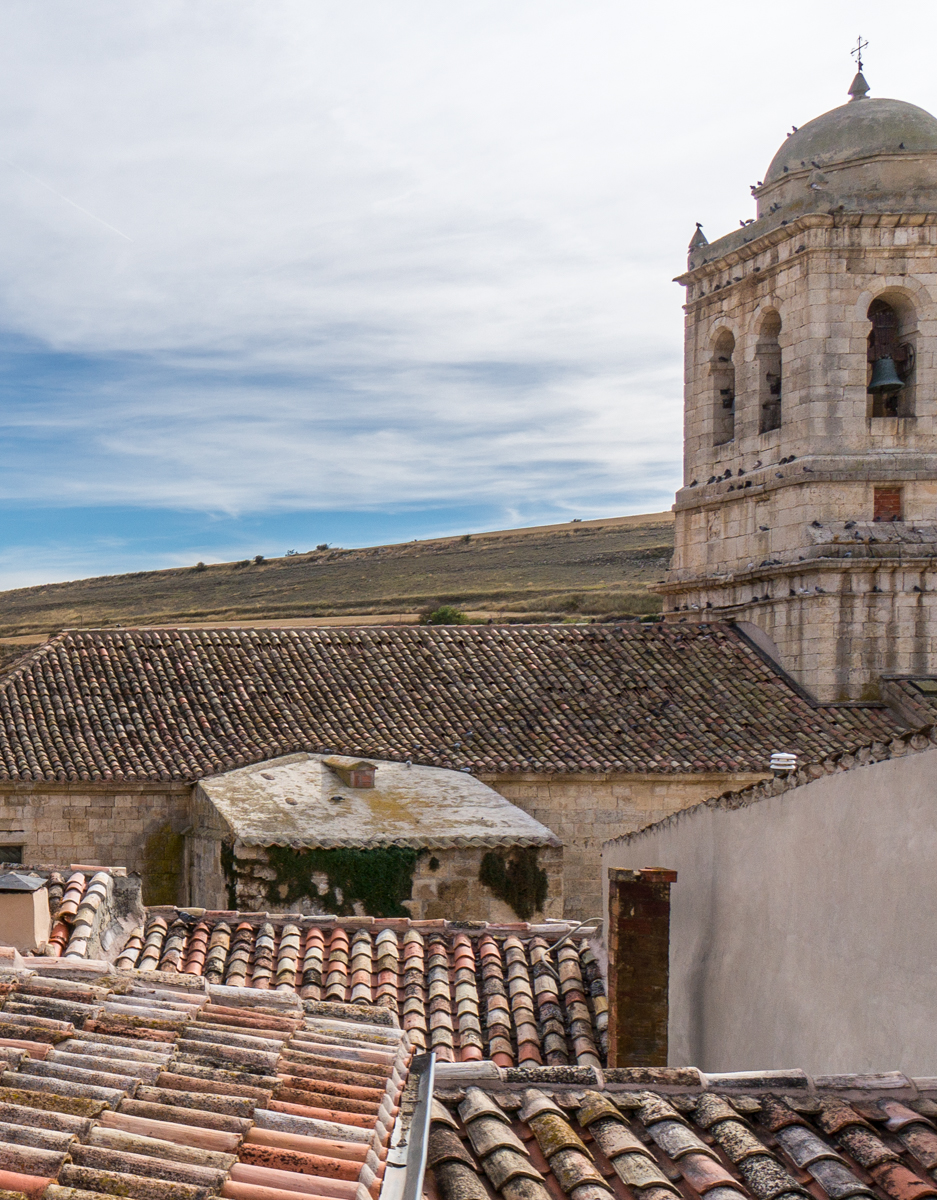 Roofs of Albergue El Puntido and the Church of the Immaculate Conception in Hontanas, Spain | Photo by Mike Hudak