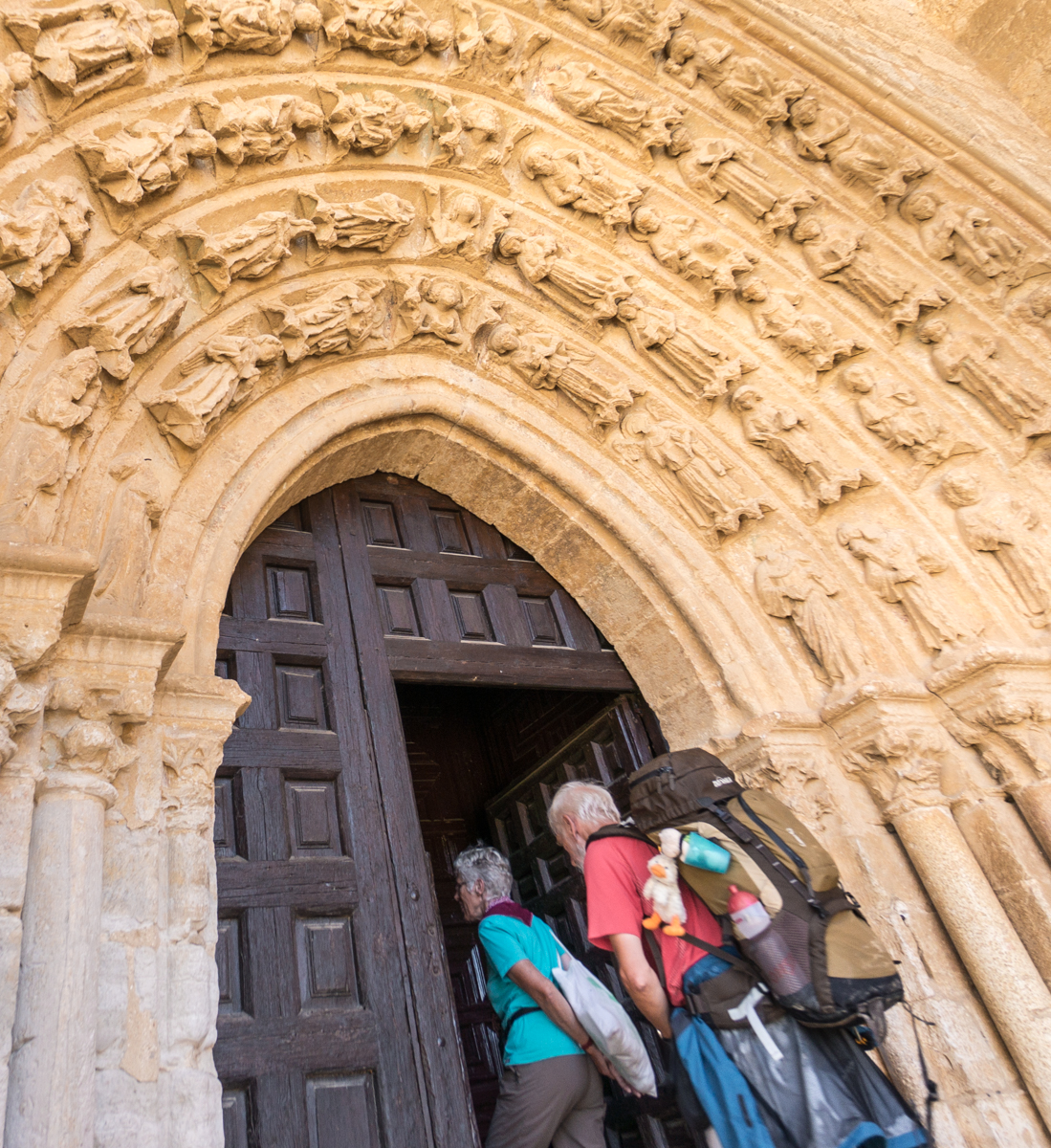 Camino pilgrims enter the Iglesia Santa María la Blanca in Villalcázar de Sirga, Spain | Photo by Mike Hudak