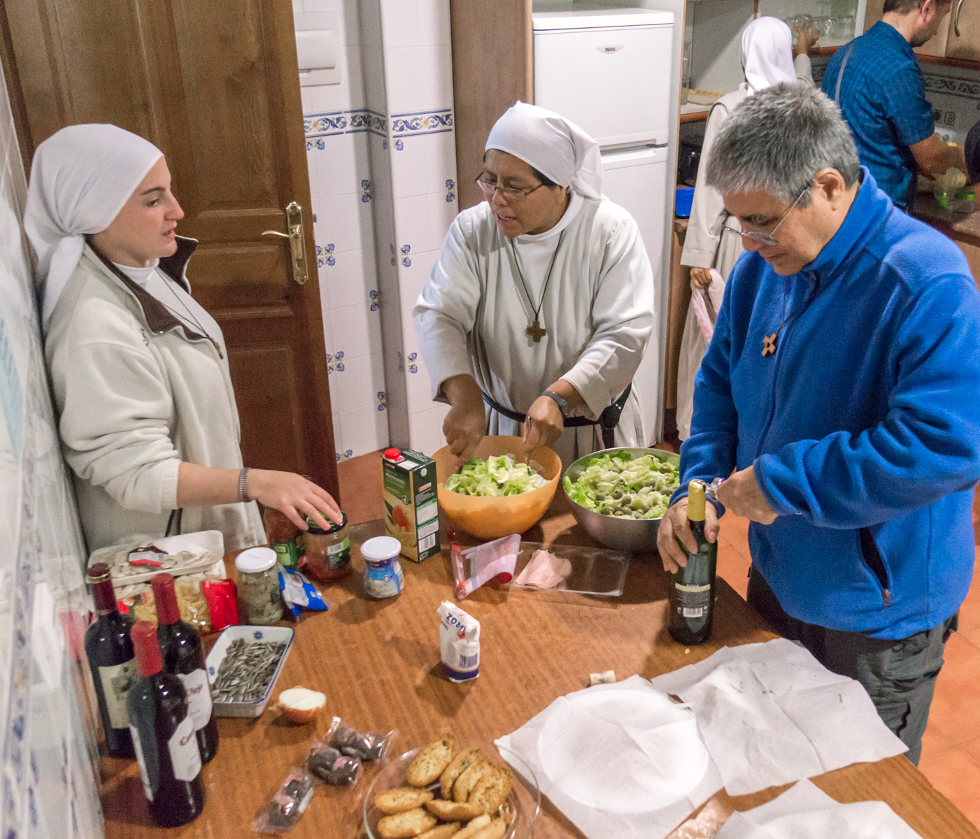 Camino pilgrims and Augustinian Nuns at Albergue Santa Maria in Carríon de los Condes prepare a communal dinner for pilgrims | Photo by Mike Hudak