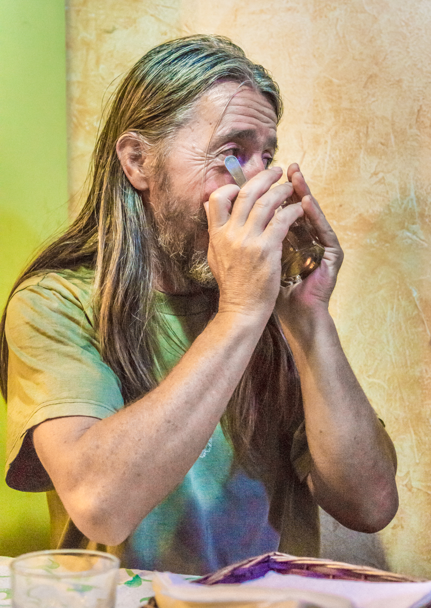 The hospitalero at Albergue Verde in Hospital de Órbigo, Spain, drinks tea with Camino pilgrims at dinner | Photo by Mike Hudak