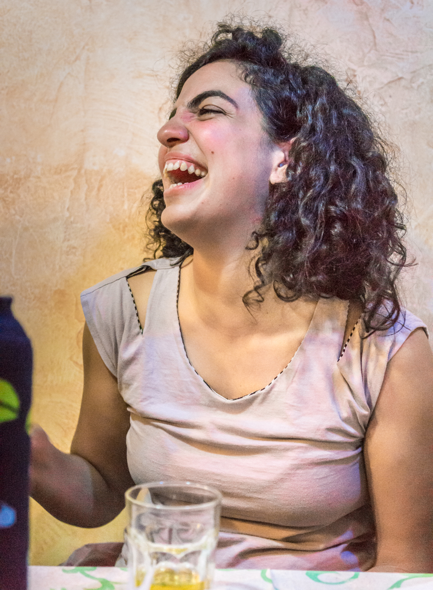 A Camino pilgrim enjoys the after-dinner conversation at Albergue Verde | Photo by Mike Hudak