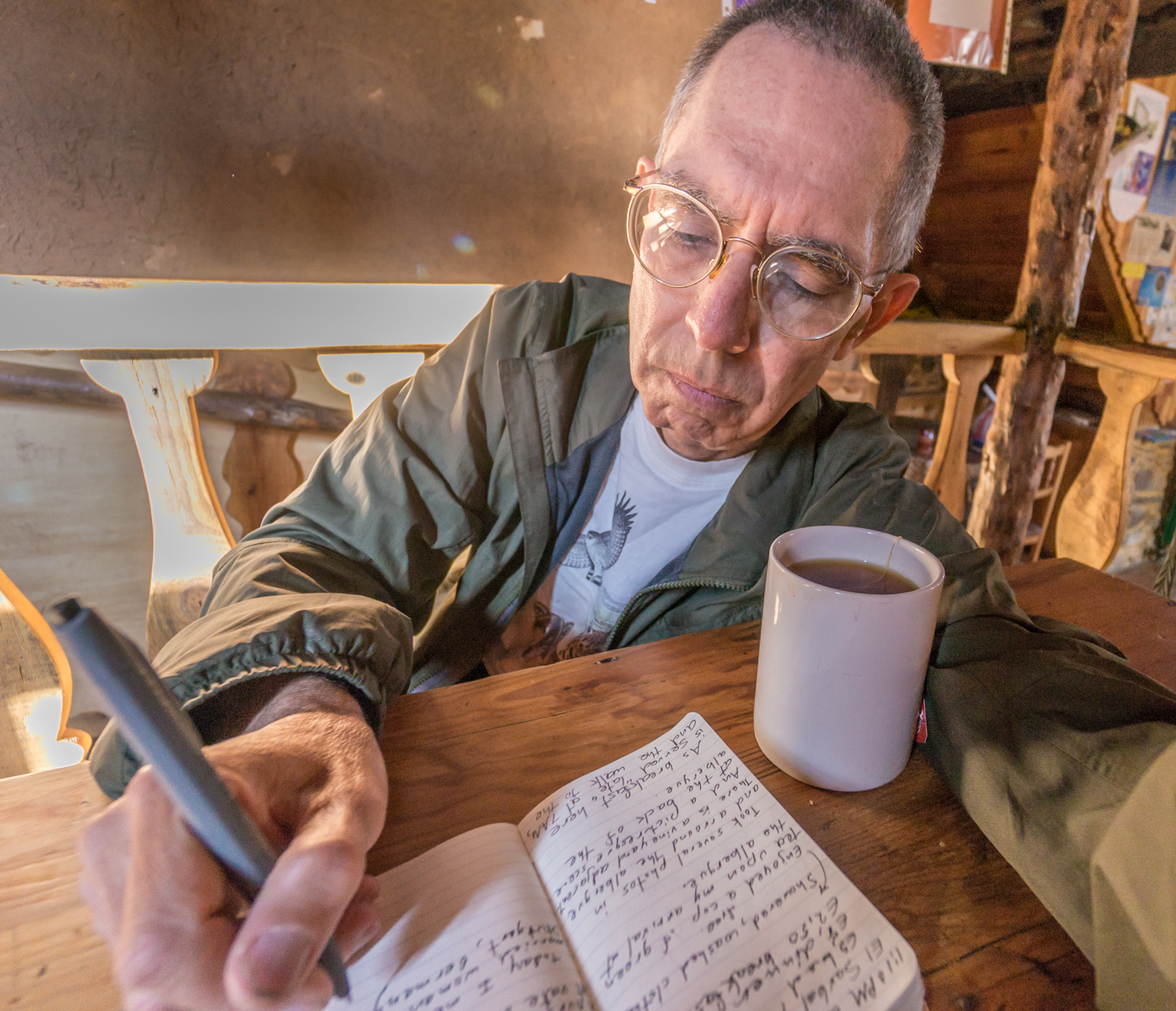 Pilgrim/photographer Mike Hudak enjoying a cup of tea and writing in his diary at Albergue El Serbal y la Luna on the Camino Francs in Pieros, Spain | Photo by Mike Hudak