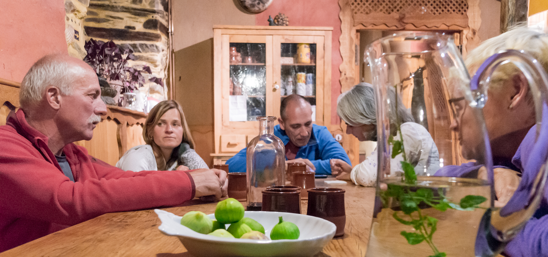 Camino pilgrims in after-dinner conversation at Albergue El Serbal y la Luna in Pieros, Spain | Photo by Mike Hudak