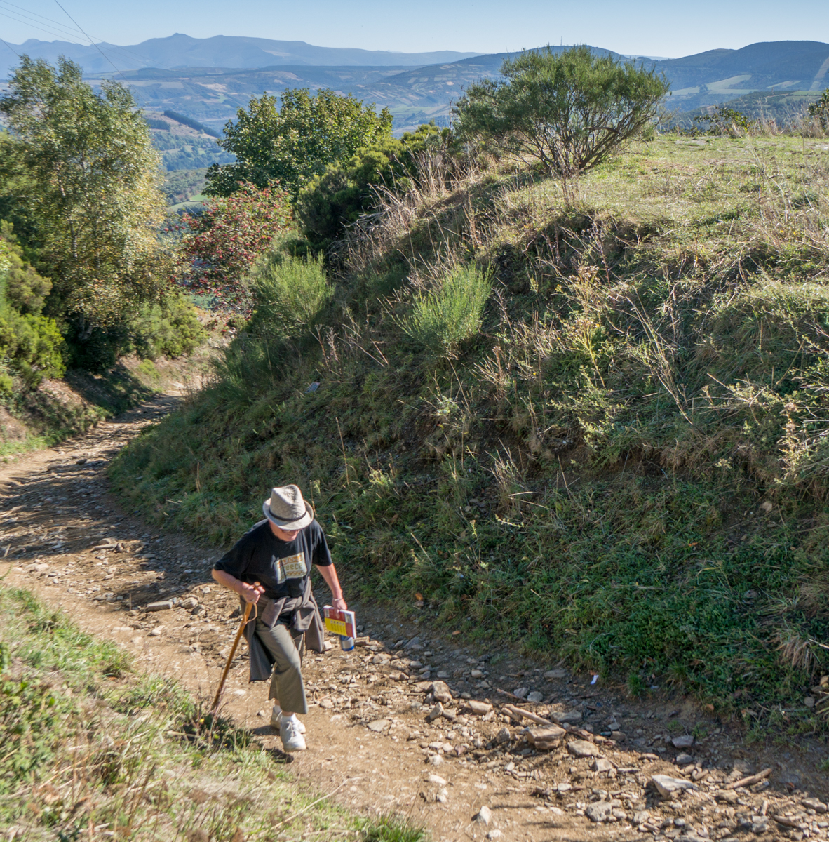 A Camino pilgrim approaches the summit of Alto do Poio, Spain | Photo by Mike Hudak
