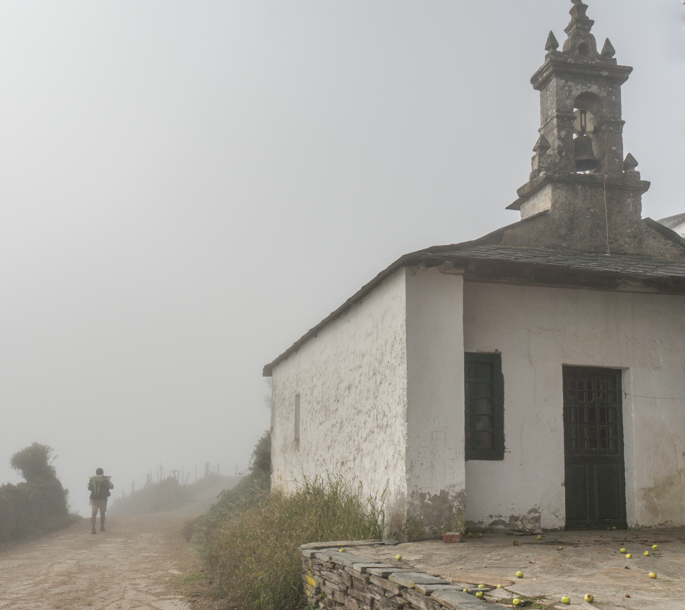 A pilgrim passes a closed chapel on the Camino Francs west of Furela, Spain | Photo by Mike Hudak