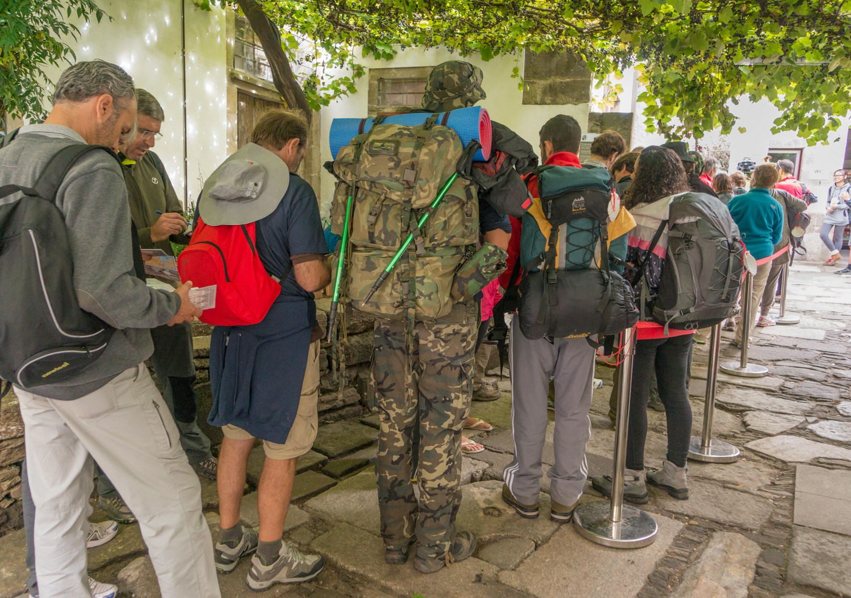 Camino pilgrims wait to enter the Pilgrims' Office in Santiago de Compostela, Spain | Photo by Mike Hudak