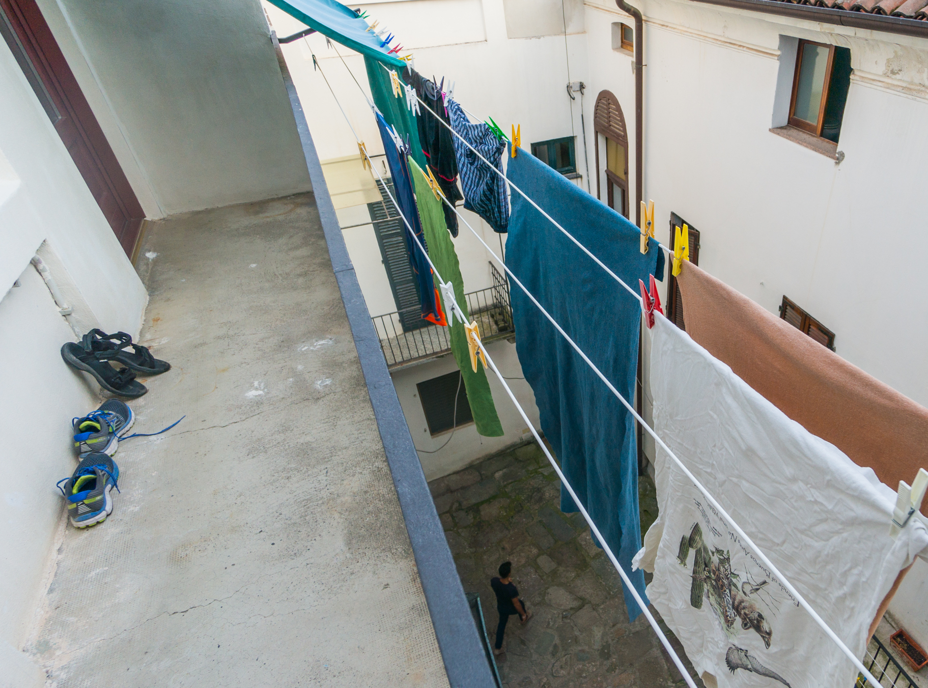 Drying clothes and shoes of pilgrims walking the Via Francigena at an ostello in Santhia, Italy | Photo by Mike Hudak.