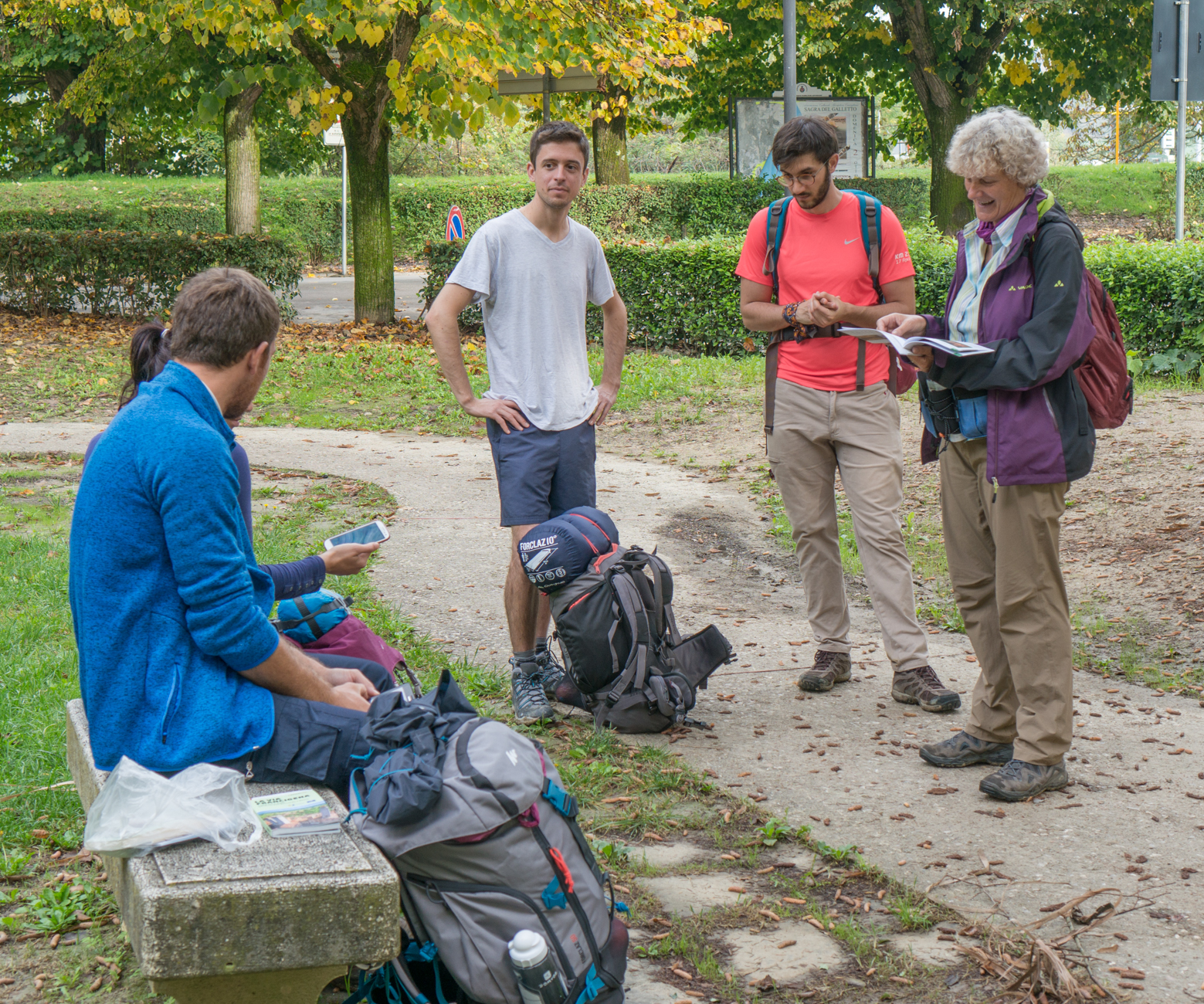 Pilgrims on the Via Francigena in Buoncovento, Italy, discuss the upcoming pilgrimage route | Photo by Mike Hudak
